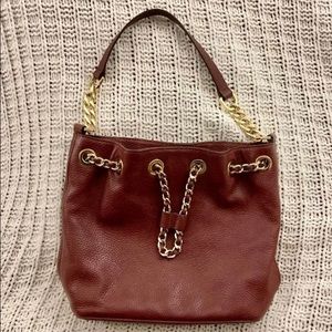Michael Kors Maroon Pebbled Leather drawstring purse with gold toned hardware
